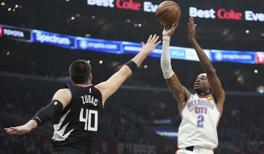Oklahoma City Thunder guard Shai Gilgeous-Alexander, right, shoots as LA Clippers center Ivica Zubac defends during the first half of an NBA basketball game Thursday, March 23, 2023, in Los Angeles. (AP Photo/Mark J. Terrill)