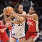 UConn guard Caroline Ducharme (33) holds onto the ball as Ohio State&#x27;s Cotie McMahon (32) and Taylor Thierry (2) attempt to steal possession during the second quarter of a Sweet 16 college basketball game of the NCAA Tournament in Seattle, Saturday, March 25, 2023. (AP Photo/Caean Couto)