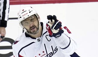 Washington Capitals&#x27; Alex Ovechkin celebrates after getting his 42nd goal of the season during the third period of an NHL hockey game against the Pittsburgh Penguins in Pittsburgh, Saturday, March 25, 2023. The Penguins won 4-3. (AP Photo/Gene J. Puskar)