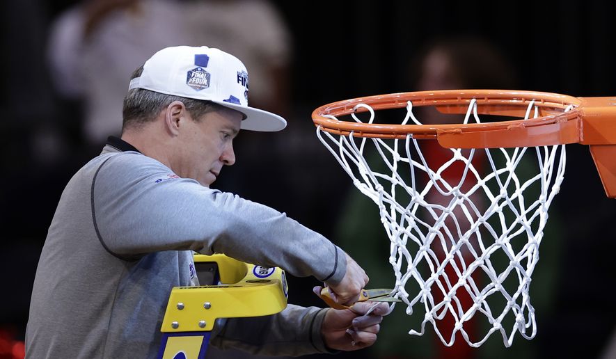 Florida Atlantic head coach Dusty May cuts the net after Florida Atlantic defeated Kansas State in an Elite 8 college basketball game in the NCAA Tournament&#x27;s East Region final, Saturday, March 25, 2023, in New York. (AP Photo/Adam Hunger)