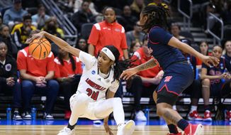 Louisville guard Morgan Jones (24) attempts to maintain control of the basketball as she falls backward during the second quarter of the team&#x27;s Sweet 16 college basketball game against Mississippi in the women&#x27;s NCAA Tournament in Seattle, Friday, March 24, 2023. (AP Photo/Caean Couto)