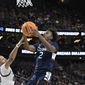 UConn guard Tristen Newton (2) shoots while defended by Gonzaga guard Rasir Bolton in the first half of an Elite 8 college basketball game in the West Region final of the NCAA Tournament, Saturday, March 25, 2023, in Las Vegas. (AP Photo/David Becker)