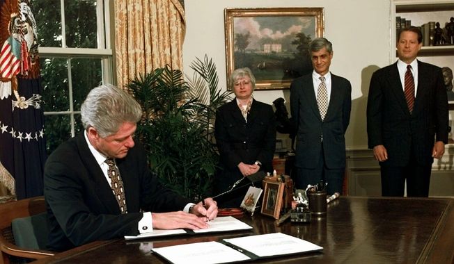 President Bill Clinton vetoes portions of the federal budget and tax-cut law in the Oval Office of the White House Aug. 11, 1997, as Vice President Al Gore, far right, Treasury Secretary Robert Rubin and Council of Economic Advisers Chairman Janet Yellen look on. (AP Photo/Ruth Fremson, File)
