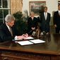 President Bill Clinton vetoes portions of the federal budget and tax-cut law in the Oval Office of the White House Aug. 11, 1997, as Vice President Al Gore, far right, Treasury Secretary Robert Rubin and Council of Economic Advisers Chairman Janet Yellen look on. (AP Photo/Ruth Fremson, File)