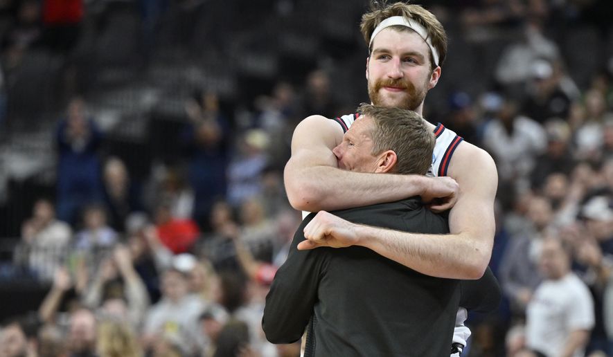 Gonzaga forward Drew Timme hugs head coach Mark Few while checking out of the game during the final minutes in the second half of an Elite 8 college basketball game against UConn in the West Region final of the NCAA Tournament, Saturday, March 25, 2023, in Las Vegas. (AP Photo/David Becker)