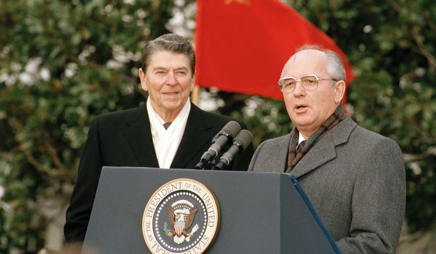 Soviet leader Mikhail Gorbachev, right, and U.S. President Ronald Reagan speak to the press in Washington, USA, Tuesday, Dec. 8, 1987. (AP Photo/Doug Mills, File)