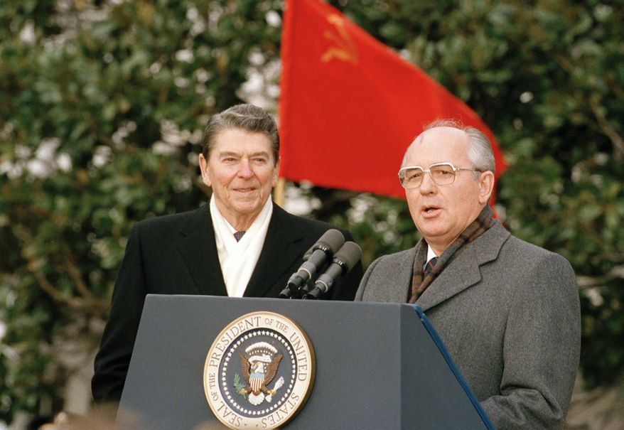 Soviet leader Mikhail Gorbachev, right, and U.S. President Ronald Reagan speak to the press in Washington, USA, Tuesday, Dec. 8, 1987. (AP Photo/Doug Mills, File)