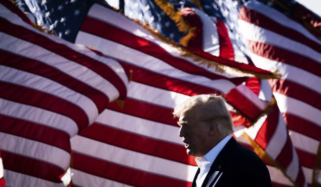 Former President Donald Trump walks to the stage to begin his Make America Great Again Rally in Waco, Texas, Saturday, March 25, 2023. (Sara Diggins/Austin American-Statesman via AP)