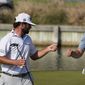 Sam Burns, right, is congratulated by Cameron Young after Burns defeated him in the final match at the Dell Technologies Match Play Championship golf tournament in Austin, Texas, Sunday, March 26, 2023. Michael Dell, left, presented the trophy. (AP Photo/Eric Gay)