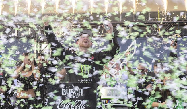 Tyler Reddick, center, celebrates after winning a NASCAR Cup Series auto race at Circuit of the Americas, Sunday, March 26, 2023, in Austin, Texas. (AP Photo/Stephen Spillman)