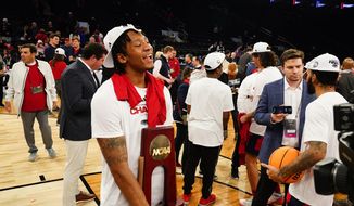 Florida Atlantic&#x27;s Isaiah Gaines (5) holds the trophy as Florida Atlantic players celebrate after defeating Kansas State in an Elite 8 college basketball game in the NCAA Tournament&#x27;s East Region final, Saturday, March 25, 2023, in New York. (AP Photo/Frank Franklin II) **FILE**