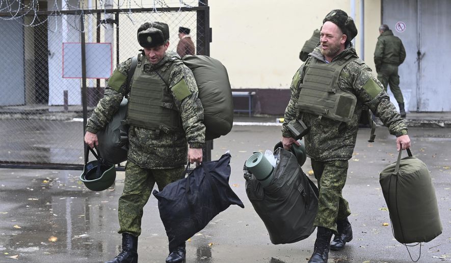 Recruits carry their new gear at a military recruitment center in Rostov-on-Don, Russia, Monday, Oct. 31, 2022. A campaign to replenish Russian troops in Ukraine with more soldiers appears to be underway again, with makeshift recruitment centers popping up in cities and towns, and state institutions posting ads promising cash bonuses and benefits to entice men to sign contracts enabling them to be sent into the battlefield. (AP Photo, File)