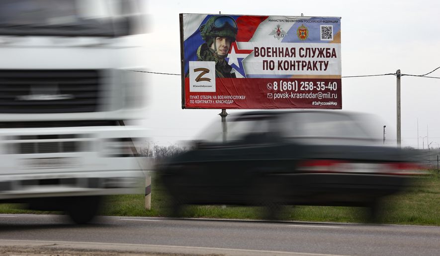 A billboard advertising &quot;Contract military service&quot; is seen beside a highway outside Krasnodar, Russia, Thursday, March 23, 2023. A campaign to replenish Russian troops in Ukraine with more soldiers appears to be underway again, with makeshift recruitment centers popping up in cities and towns, and state institutions posting ads promising cash bonuses and benefits to entice men to sign contracts enabling them to be sent into the battlefield. (AP Photo)