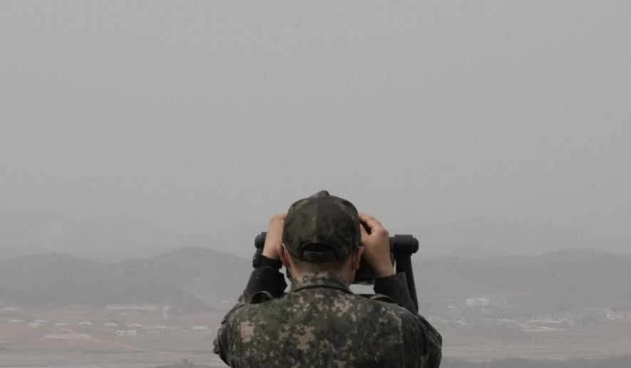 A South Korean army soldier watches the North Korea side from the Unification Observation Post in Paju, South Korea, near the border with North Korea, Friday, March 24, 2023. North Korea said Friday its cruise missile launches this week were part of nuclear attack simulations that also involved a detonation by a purported underwater drone as leader Kim Jong Un vowed to make his rivals &quot;plunge into despair.&quot; (AP Photo/Ahn Young-joon)