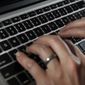 A person types on a laptop keyboard in North Andover, Mass, June 19, 2017. The U.S. government will restrict its use of commercial spyware tools that have been used to surveil human rights activists, journalists and dissidents around the world, under an executive order issued Monday, Oct. 27, 2023, by President Joe Biden. (AP Photo/Elise Amendola, File)