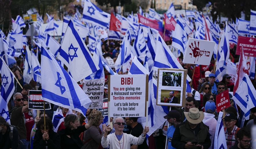 Israelis protest against Prime Minister Benjamin Netanyahu&#x27;s judicial overhaul plan outside the parliament in Jerusalem, Monday, March 27, 2023. (AP Photo/Ariel Schalit)