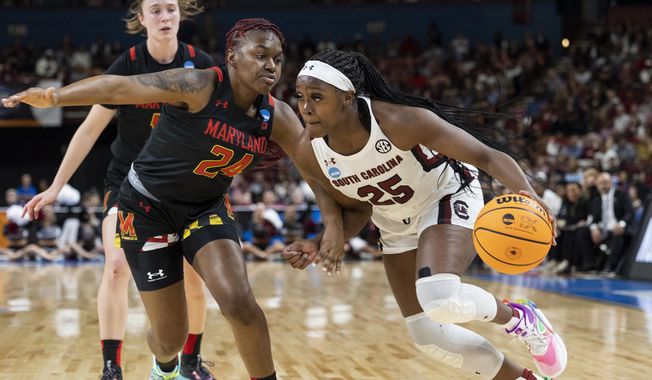 South Carolina&#x27;s Raven Johnson (25) dribbles past Maryland&#x27;s Bri McDaniel (24) in the first half of an Elite 8 college basketball game of the NCAA Tournament in Greenville, S.C., Monday, March 27, 2023. (AP Photo/Mic Smith)