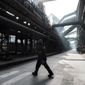 A worker walks inside the Zaporizhstal steel plant, in Zaporizhia, Ukraine, Wednesday, March 1, 2023. The southwestern city of Zaporizhzhia, which gives the plant its name, is less than 50 kilometers (31 miles) from the front line and its residential buildings and energy infrastructure are a frequent Russian target. The impact of the war has left the plant running below full capacity, with a third of its 10,000 workers idle. (AP Photo/Thibault Camus)