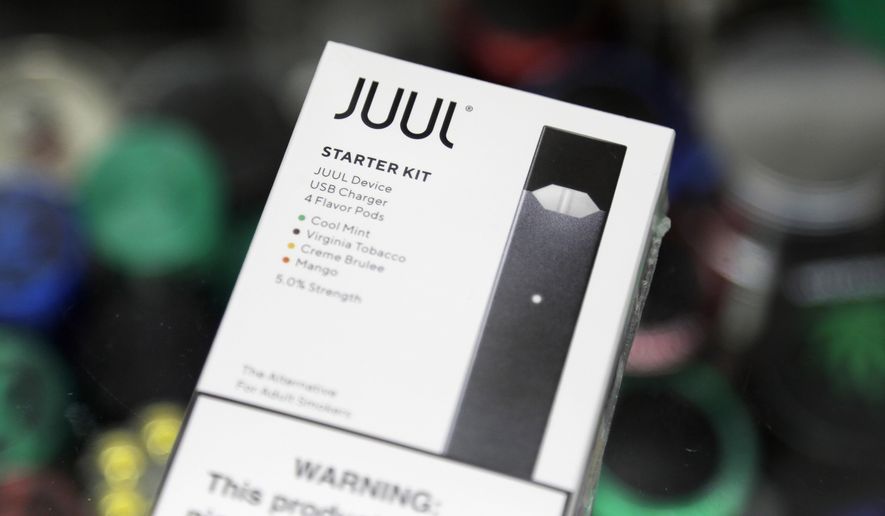 A Juul electronic cigarette starter kit is seen at a smoke shop on Dec. 20, 2018, in New York. Minnesota Attorney General Keith Ellison is slated to lead off opening statements expected for Tuesday, March 28, 2023, in his state&#x27;s lawsuit against Juul Labs – marking the first time any of the thousands of cases against the e-cigarette maker over its alleged marketing to young people is going to play out in a courtroom. (AP Photo/Seth Wenig, File)