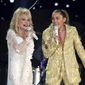FILE - Dolly Parton, left, and Miley Cyrus perform &quot;Jolene&quot; at the 61st annual Grammy Awards in Los Angeles on Feb. 10, 2019. Administrators at Heyer Elementary School in Waukesha, Wis., aren&#x27;t letting a first-grade class perform &quot;Rainbowland,&quot; a Cyrus and Parton duet from Cyrus&#x27; 2017 album &quot;Younger Now,&quot; promoting LGBTQ acceptance, because they say the song could be seen as controversial. (Photo by Matt Sayles/Invision/AP, File)