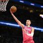 Washington Wizards center Kristaps Porzingis (6) goes to the basket during the first half of an NBA basketball game against the Boston Celtics, Tuesday, March 28, 2023, in Washington. (AP Photo/Nick Wass)
