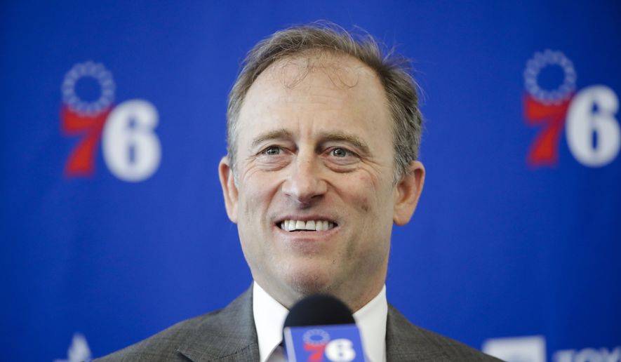 FILE - Philadelphia 76ers owner Josh Harris speaks with members of the media during a news conference at the NBA basketball team&#x27;s practice facility in Camden, N.J., Tuesday, May 14, 2019. Two people with knowledge of the situation tells The Associated Press a group led by Josh Harris and Mitchell Rales has submitted a fully financed bid for the NFL&#x27;s Washington Commanders. The Harris/Rales group, which includes basketball Hall of Famer Magic Johnson, is one of multiple bidders involved in the sale process .(AP Photo/Matt Rourke, File)