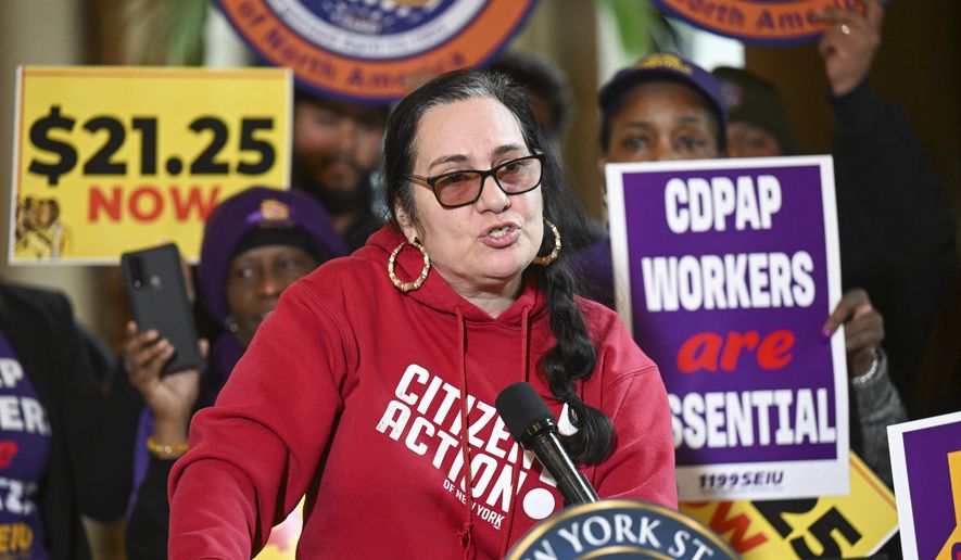 Rosemarry Rivera, of Citizen Action of New York, stands with protesters urging lawmakers to raise New York&#x27;s minimum wage during a rally at the state Capitol, Monday, March 13, 2023, in Albany, N.Y. (AP Photo/Hans Pennink)