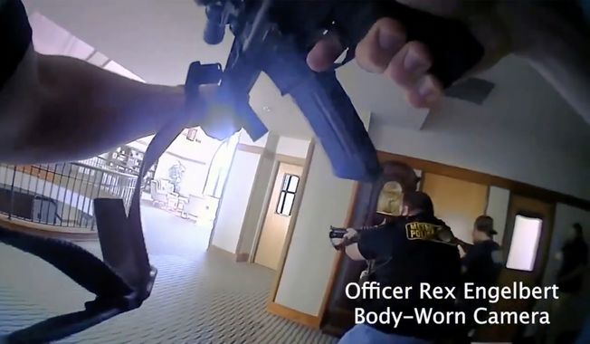 This image provided by Metropolitan Nashville Police Department shows bodycam footage of police responding to an active shooting at The Covenant School in Nashville, Tenn., on Monday, March 27, 2023. The former student who shot through the doors of the Christian elementary school and killed three children and three adults had drawn a detailed map of the school.   (Metropolitan Nashville Police Department via AP)