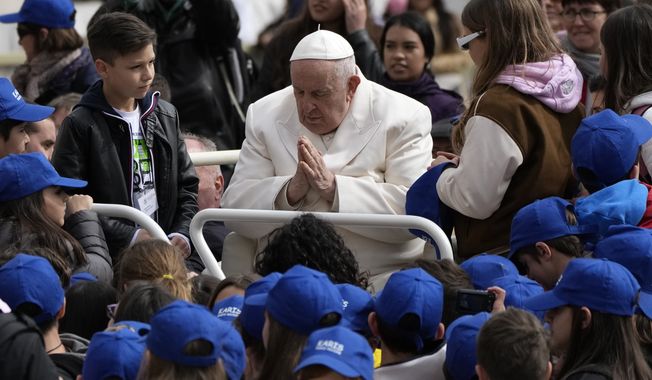 Pope Francis meets children at the end of his weekly general audience in St. Peter&#x27;s Square, at the Vatican, Wednesday, March 29, 2023. Pope Francis went to a Rome hospital on Wednesday for some previously scheduled tests, slipping out of the Vatican after his general audience and before the busy start of Holy Week this Sunday. (AP Photo/Alessandra Tarantino)