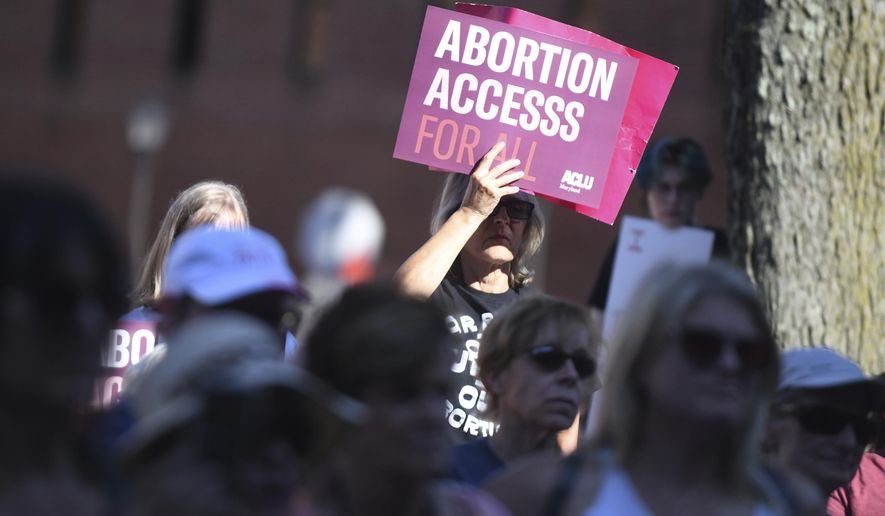 A woman holds a sign while joined by other supporters during an abortion rights rally in The People&#x27;s Park in Annapolis, Md., June 24, 2022. In 2024, Maryland voters will decide whether to enshrine the right to abortion in the state&#x27;s constitution, after the House of Delegates voted Thursday, March 30, 2023, to put a constitutional amendment on the ballot. (Brian Krista/The Baltimore Sun via AP, File)