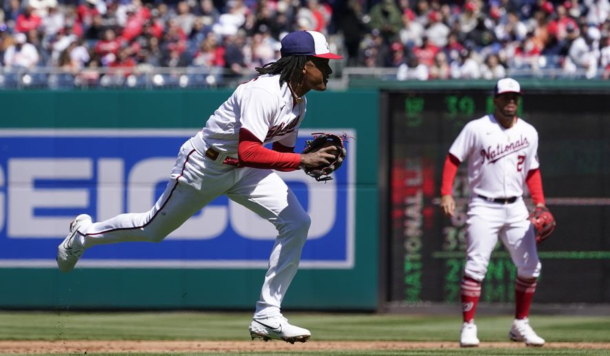 Washington Nationals shortstop CJ Abrams attempts to field a ground ball during an opening day baseball game against the Atlanta Braves at Nationals Park, Thursday, March 30, 2023, in Washington. (AP Photo/Alex Brandon)