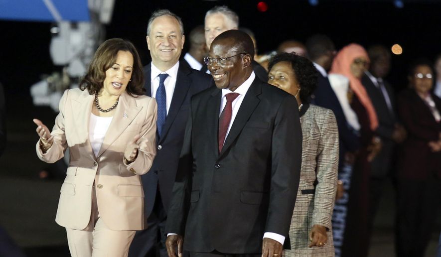 Vice President Kamala Harris talks with Tanzania's Vice President Philip Mpango as she arrives at the Julius Nyerere Airport in Dar es Salaam, Tanzania, Wednesday, March 29, 2023, the second stop of a three-nation tour of Africa. (Emmanuel Herman/Pool Photo via AP)
