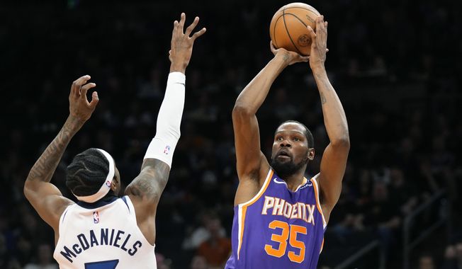 Phoenix Suns forward Kevin Durant (35) shoots over Minnesota Timberwolves forward Jaden McDaniels, left, during the second half of an NBA basketball game Wednesday, March 29, 2023, in Phoenix. The Suns won 107-100. (AP Photo/Ross D. Franklin)