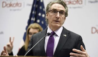 North Dakota Gov. Doug Burgum speaks at the state Capitol on April 10, 2020, in Bismarck, N.D. Burgum on Thursday, March 30, 2023, vetoed a bill that would prohibit public schools teachers and staff from referring to transgender students by pronouns other than those reflecting the sex assigned to them at birth in most cases. (Mike McCleary/The Bismarck Tribune via AP, File)