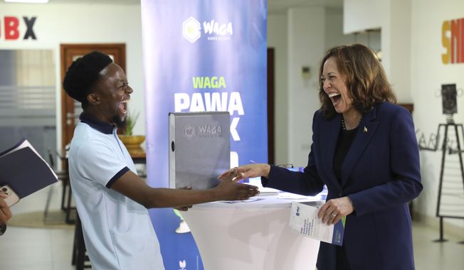 U.S. Vice President, Kamala Harris shares a light moment with Tanzanian climate entrepreneur, Gibson Kiwago at the SNDBX Space, a space for freelancers, entrepreneurs, builders, innovators and creatives, in Dar es Salaam, Tanzania, Thursday, March 30, 2023. (Ericky Boniphace/Pool Photo via AP)