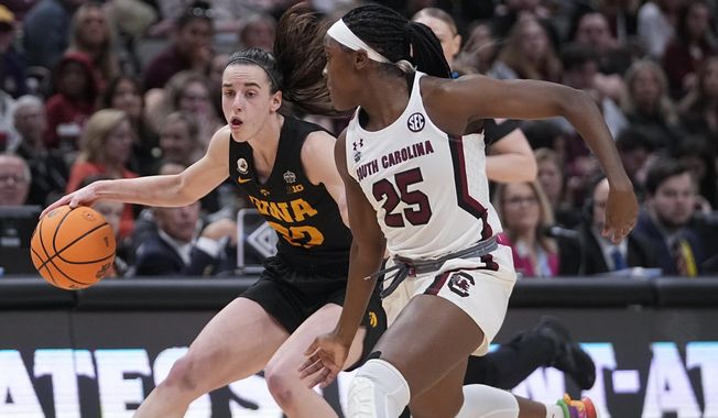 Iowa&#x27;s Caitlin Clark tries to get past South Carolina&#x27;s Raven Johnson during the first half of an NCAA Women&#x27;s Final Four semifinals basketball game Friday, March 31, 2023, in Dallas. (AP Photo/Darron Cummings)