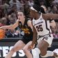 Iowa&#x27;s Caitlin Clark tries to get past South Carolina&#x27;s Raven Johnson during the first half of an NCAA Women&#x27;s Final Four semifinals basketball game Friday, March 31, 2023, in Dallas. (AP Photo/Darron Cummings)