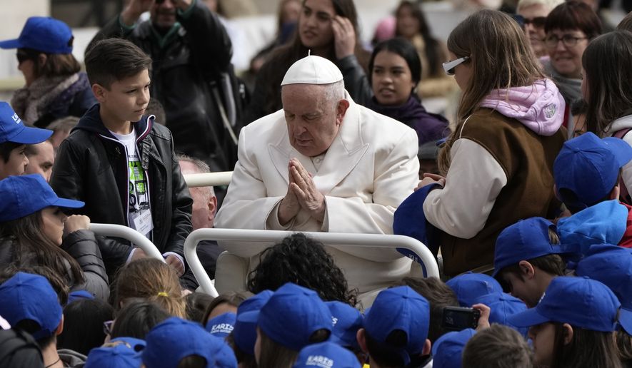 Pope Francis meets children at the end of his weekly general audience in St. Peter&#x27;s Square, at the Vatican, Wednesday, March 29, 2023. (AP Photo/Alessandra Tarantino)