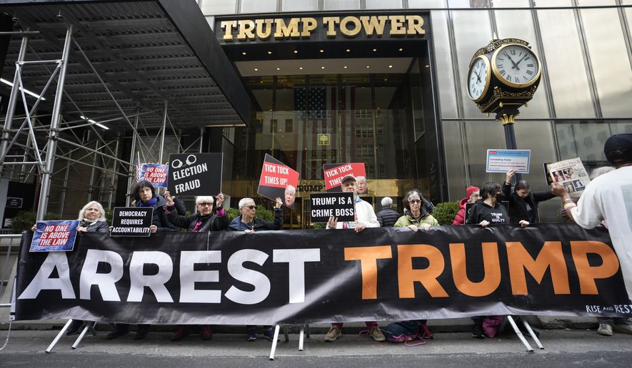 Protesters gather outside Trump Tower on Friday, March 31, 2023, in New York.  Former President Donald Trump was indicted by a Manhattan grand jury, Thursday, a historic reckoning after years of investigations into his personal, political and business dealings and an abrupt jolt to his bid to retake the White House.(AP Photo/Bryan Woolston)