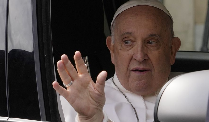 Pope Francis waves from his car as he arrives at The Vatican, Saturday, April 1, 2023, after receiving treatment at the Agostino Gemelli University Hospital for bronchitis, The Vatican said. Francis was hospitalized on Wednesday after his public general audience in St. Peter&#x27;s Square at The Vatican. (AP Photo/Andrew Medichini)