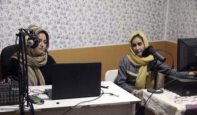 Najia Sorosh (left), head of Sadai Banowan, a women-run radio station, speaks into a microphone in the broadcasting studio in Badakhshan province, northeastern of Afghanistan, Wednesday, Jan. 4, 2023. (Sadai Banowan via AP) **FILE**