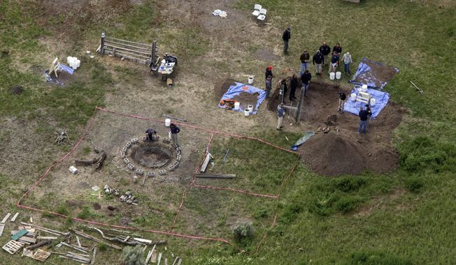 In this aerial photo, investigators search for human remains at Chad Daybell&#x27;s residence in Salem, Idaho, on June 9, 2020. A mother charged with murder in the deaths of her two children is set to stand trial in Idaho. The proceedings against Lori Vallow Daybell, the wife of Chad Daybell, beginning Monday, April 3, 2023, could reveal new details in the strange, doomsday-focused case. (John Roark/The Idaho Post-Register via AP, File)