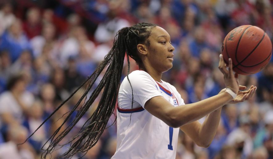 Kansas center Taiyanna Jackson passes the ball after a rebound against Columbia during the first half of an NCAA college basketball game for the WNIT championship Saturday, April 1, 2023, in Lawrence, Kan. (Evert Nelson/The Topeka Capital-Journal via AP)