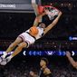 Connecticut guard Andre Jackson Jr. dunks the ball over Miami forward Norchad Omier, right, during the second half of a Final Four college basketball game in the NCAA Tournament on Saturday, April 1, 2023, in Houston. (AP Photo/David J. Phillip)