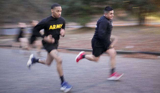 Army Staff Sgt. Daniel Murillo, right, runs up hill as part of his physical training at Ft. Bragg on Wednesday, Jan. 18, 2023, in Fayetteville, N.C. Obesity in the U.S. military surged during the pandemic, new research shows. Nearly 10,000 active duty Army soldiers became newly obese between February 2019 and June 2021, after restricted duty and limited exercise led to higher body mass scores. (AP Photo/Chris Carlson)