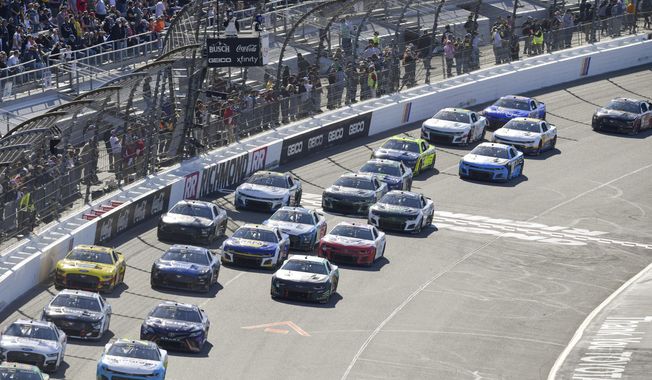 Drivers restart after a caution flag during a NASCAR Cup Series auto race at Richmond Raceway on Sunday, April 2, 2023, in Richmond, Va. (AP Photo/Mike Caudill)