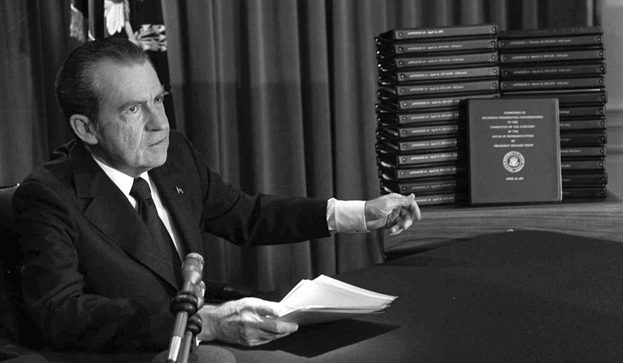President Richard M. Nixon points to the transcripts of the White House tapes after he announced during a nationally-televised speech that he would turn over the transcripts to House impeachment investigators, in Washington, April 29, 1974. In 1974, Richard Nixon may well have avoided criminal charges on obstruction of justice or bribery, related to the Watergate scandal, only because President Gerald Ford pardoned him just weeks after Nixon resigned the presidency.  (AP Photo/File)