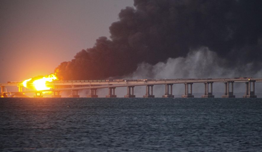 Flame and smoke rise from Crimean Bridge connecting Russian mainland and Crimean peninsula over the Kerch Strait, after what Russian authorities said was a bomb caused fire and partial collapse of the bridge, in Kerch, Crimea, Saturday, Oct. 8, 2022. A top Ukrainian official on Sunday, April 2, 2023, outlined a series of steps the government in Kyiv would take after the country reclaims control of Crimea, including dismantling the strategic bridge that links the seized Black Sea peninsula to Russia. (AP Photo, File)