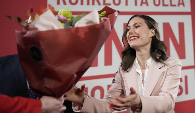 Finnish Prime Minister Sanna Marin, Social Democratic Party is presented flowers during an election party in Helsinki, Finland, Sunday, April 2, 2023. Finland&#x27;s center-right National Coalition Party claimed victory with 97.7% of votes counted in an extremely tight three-way parliamentary race. They appeared to beat the ruling Social Democrats led by Prime Minister Sanna Marin. (AP Photo/Sergei Grits)