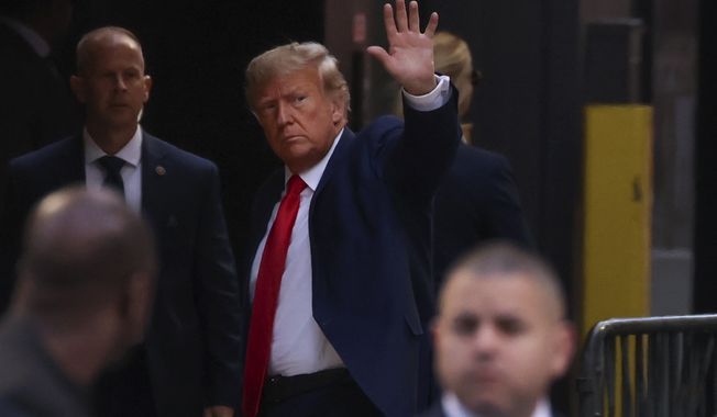 Former President Donald Trump waves to supporters upon arriving at Trump Tower, Monday, April 3, 2023, in New York. Trump arrived in New York on Monday for his expected booking and arraignment the following day on charges arising from hush money payments during his 2016 campaign. (AP Photo/Yuki Iwamura)